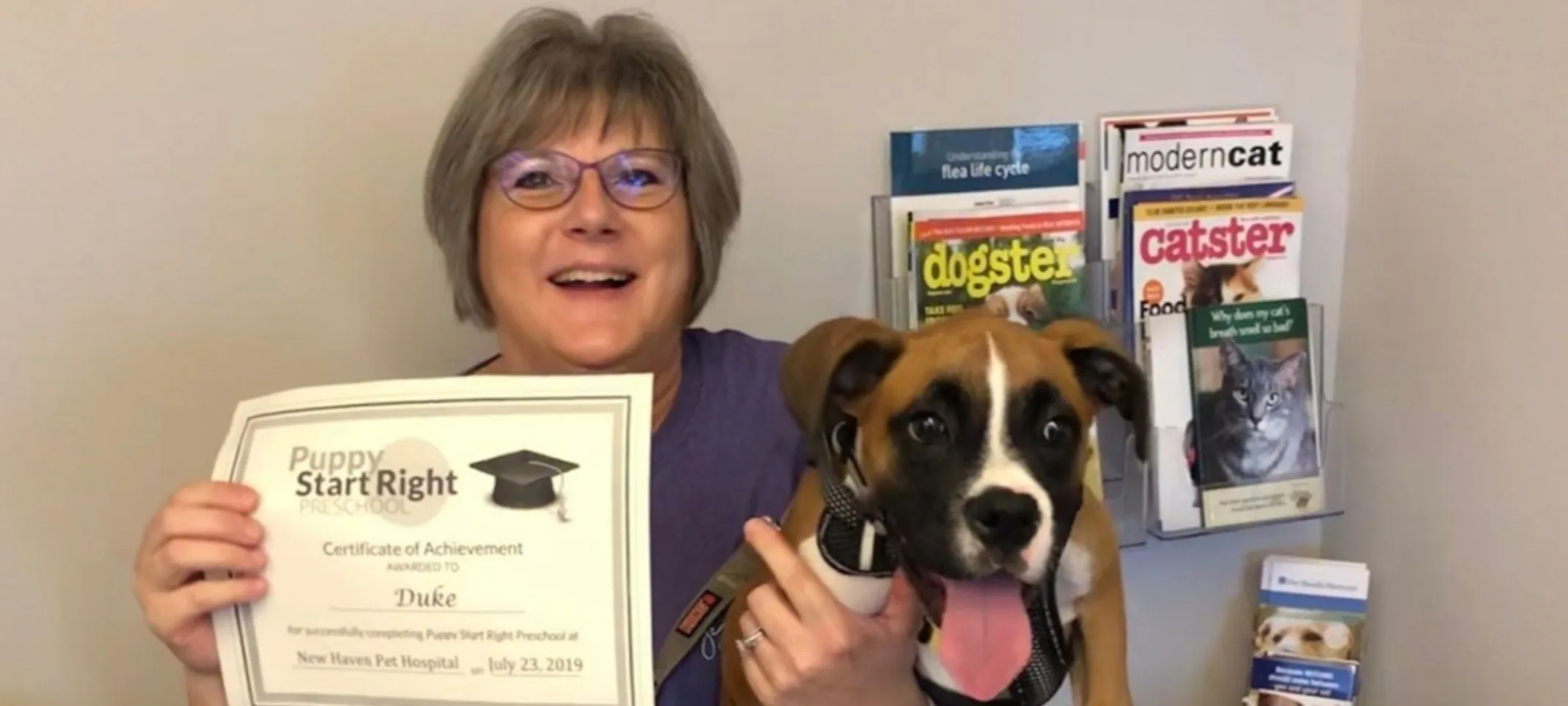 Owner and puppy with certificate at New Haven Pet Hospital